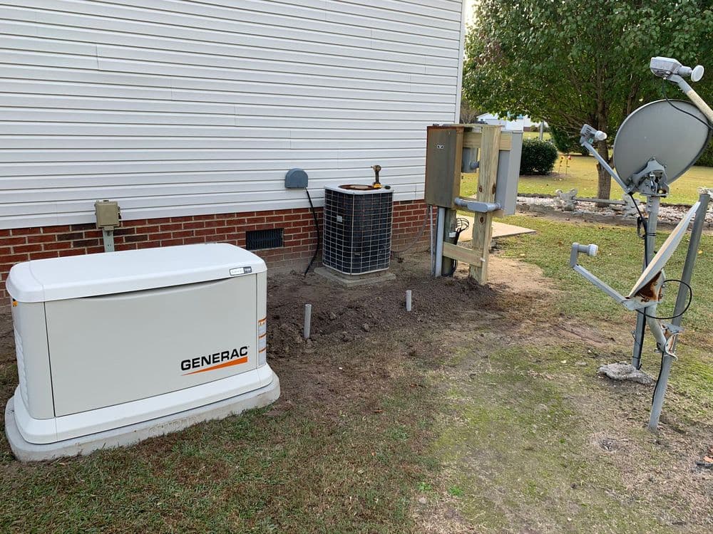 Generac home generator beside air conditioning unit and satellite dish installation.