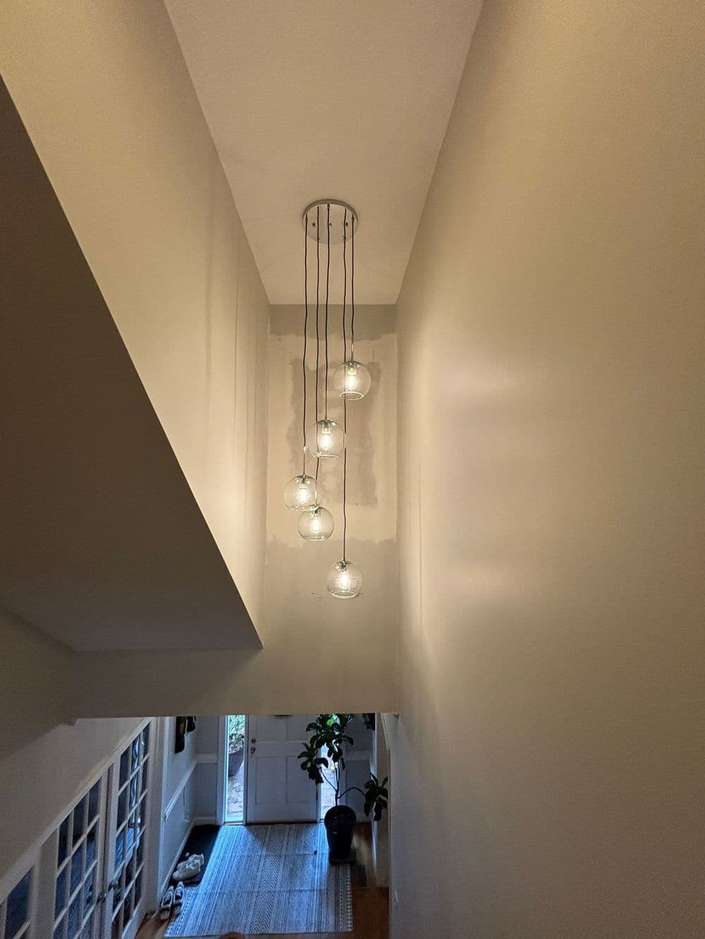 Modern pendant lights hanging in a stylish hallway, illuminating a contemporary space.